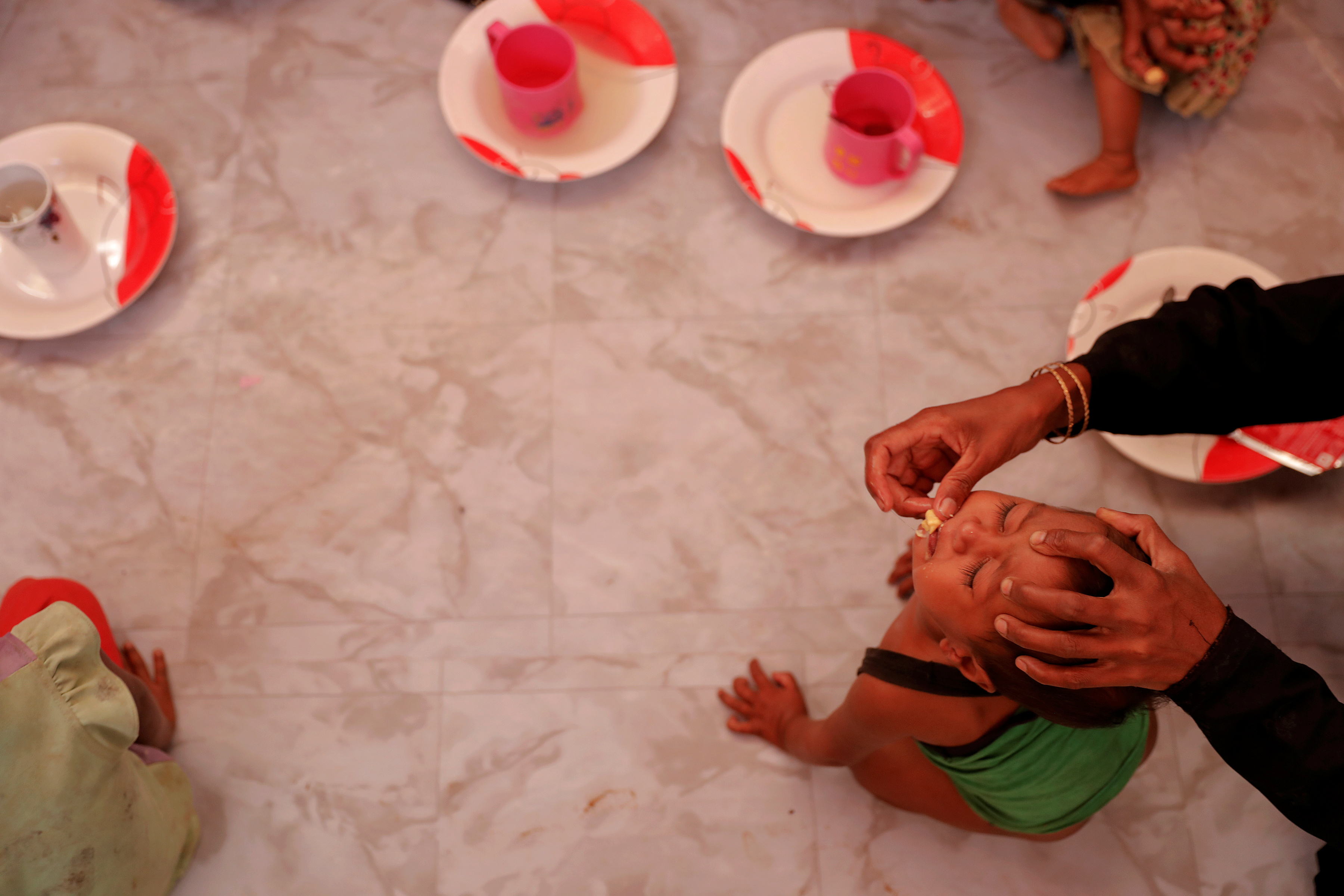 A malnourished child is fed at UNICEF medical centre at Balukhali refugee camp near Cox's Bazar, Bangladesh December 4, 2017. REUTERS/Damir Sagolj
