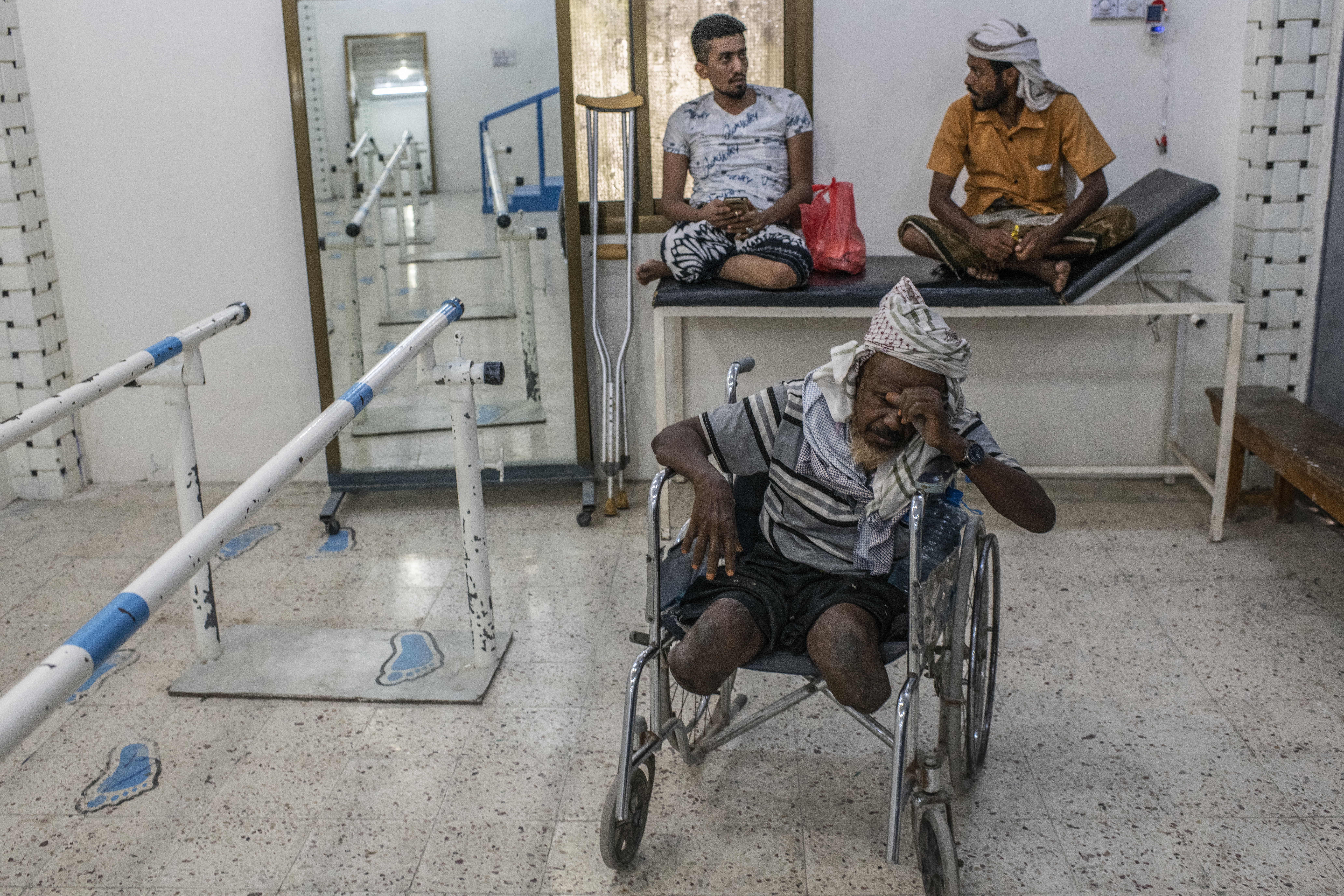 A man waits to be fitted for a set of prosthetic limbs at a government health clinic in Aden.