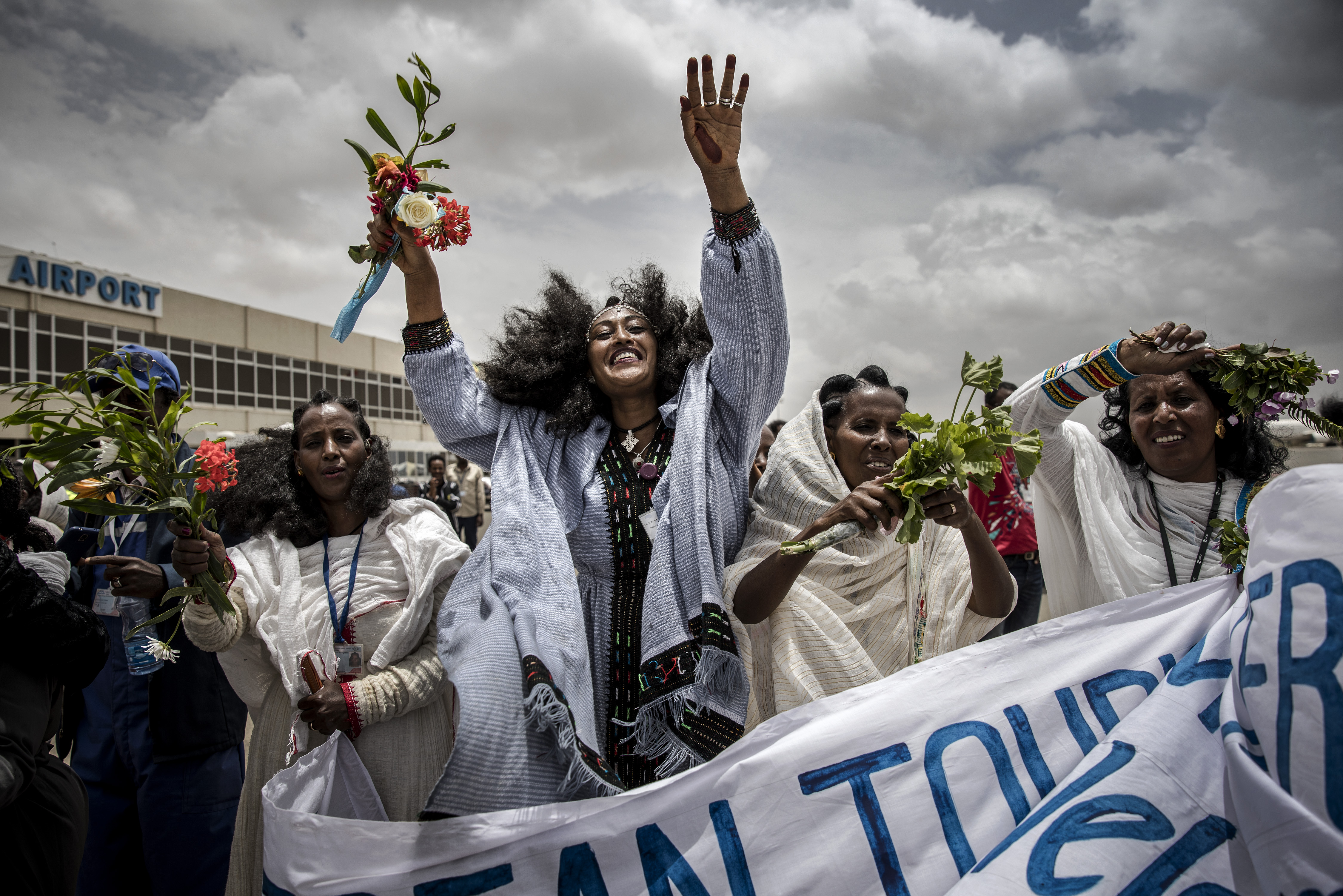 Eritrean women celebrate on the tarmac to welcome passengers of a flight from Addis Ababa, Ethiopia, in Asmara, Eritrea.