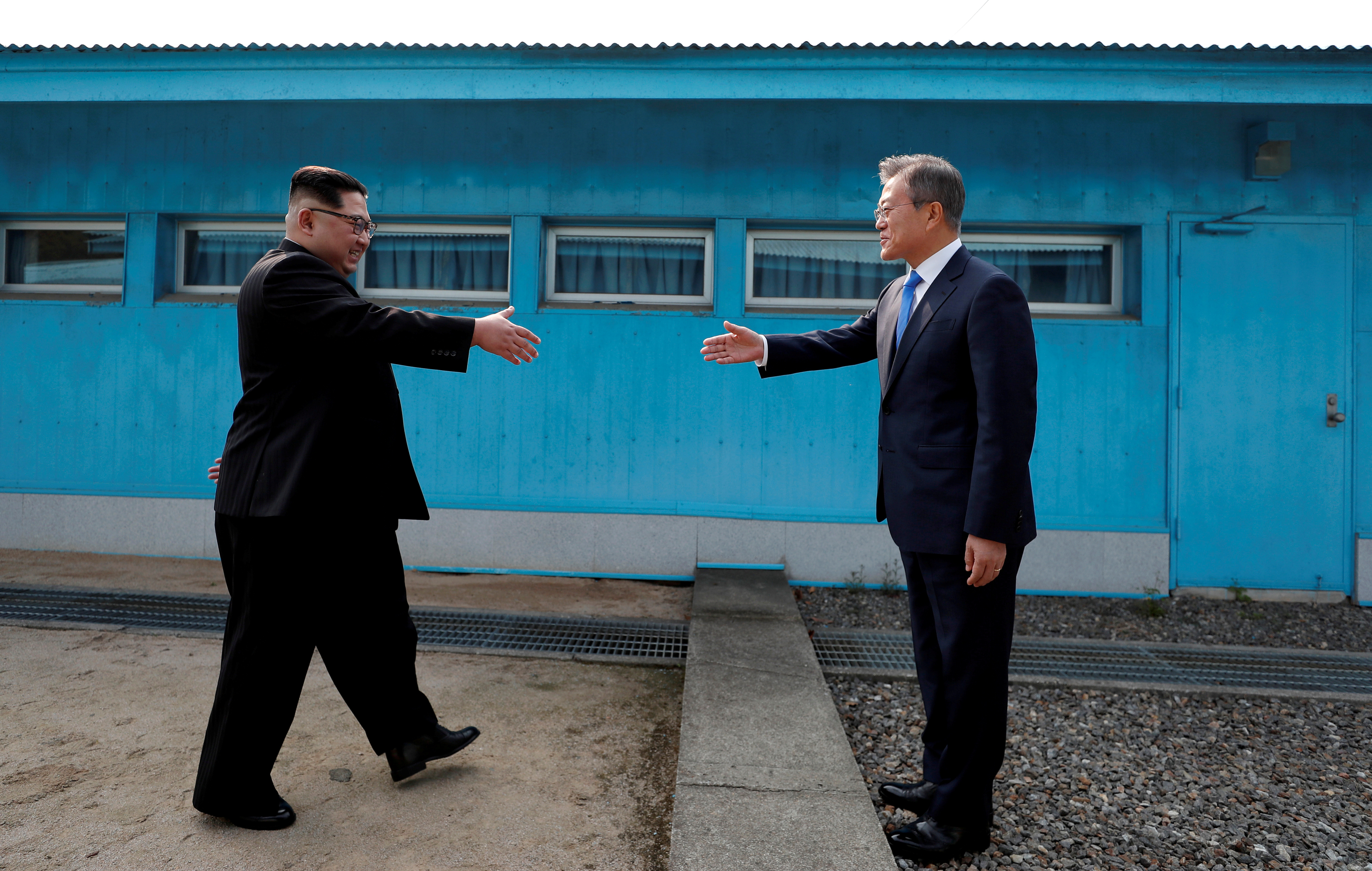 South Korean President Moon Jae-in and North Korean leader Kim Jong-un shake hands at the truce village of Panmunjom.