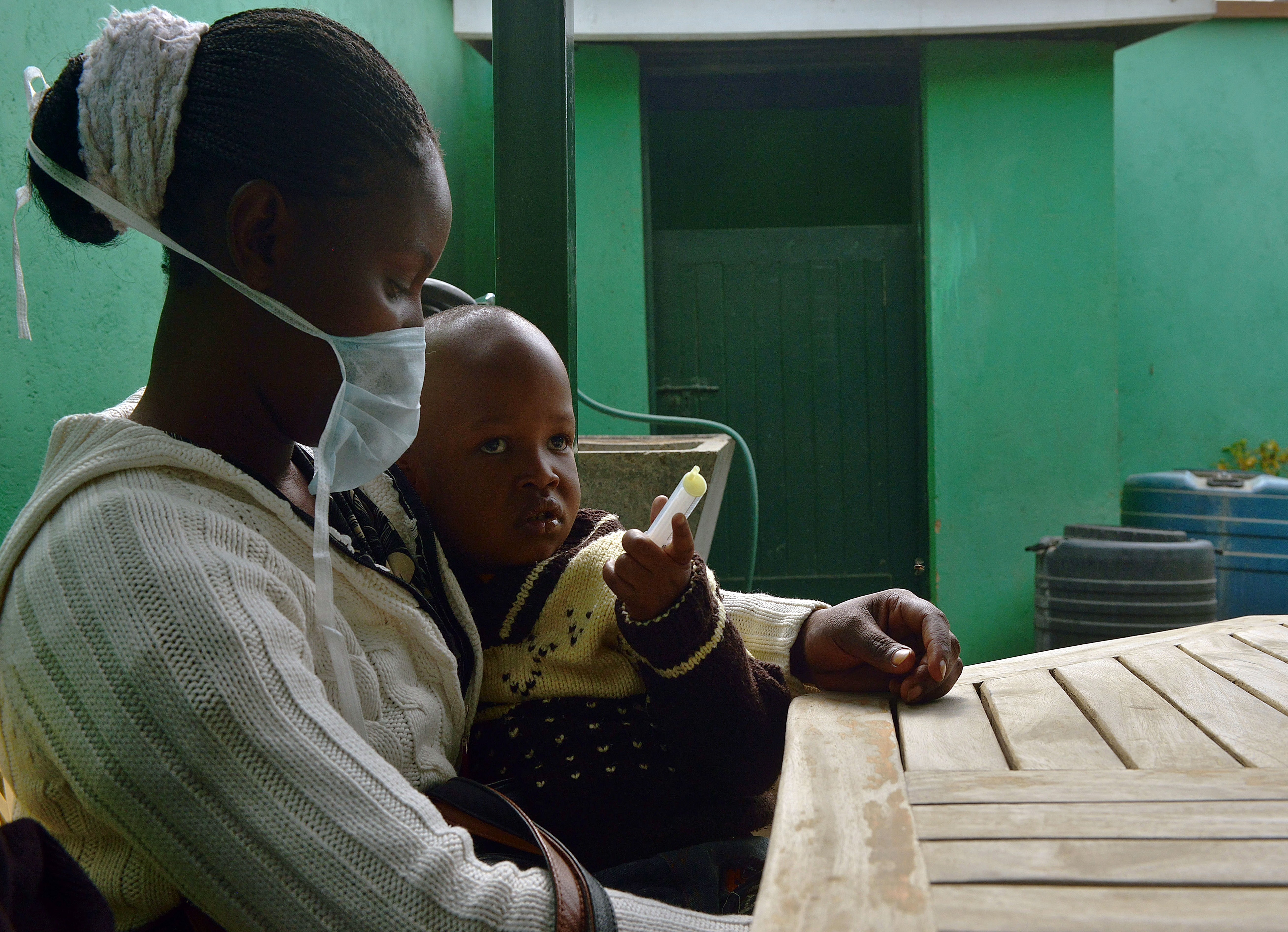 A mother holds her three-year-old boy, who suffers from multidrug-resistant tuberculosis, after giving him medication at a Doctors Without Borders–run clinic in Nairobi, Kenya, on World Tuberculosis Day.