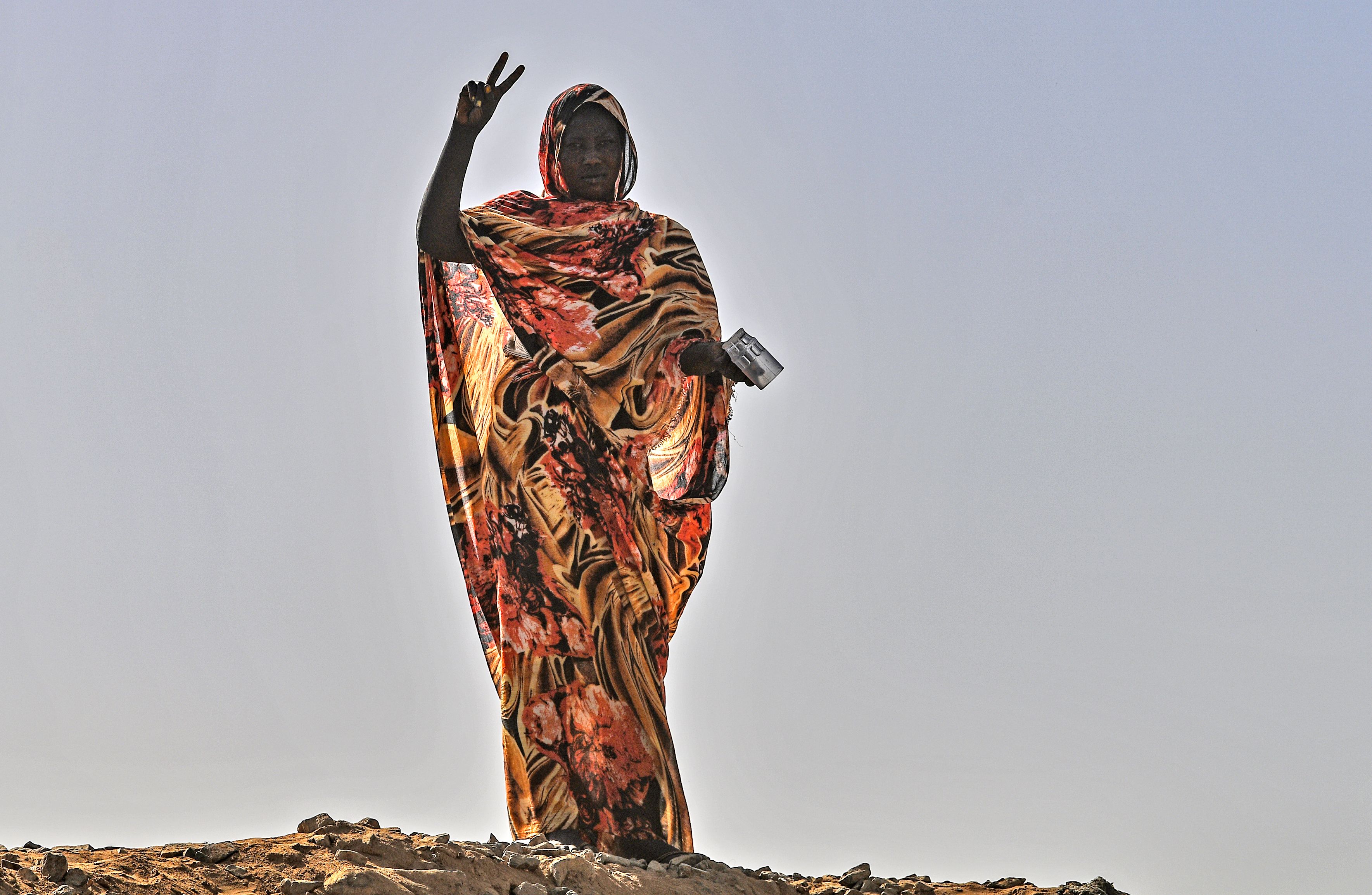 A Sudanese protester flashes the V for victory signr during a sit-in outside the army headquarters in the capital Khartoum on April 30, 2019.