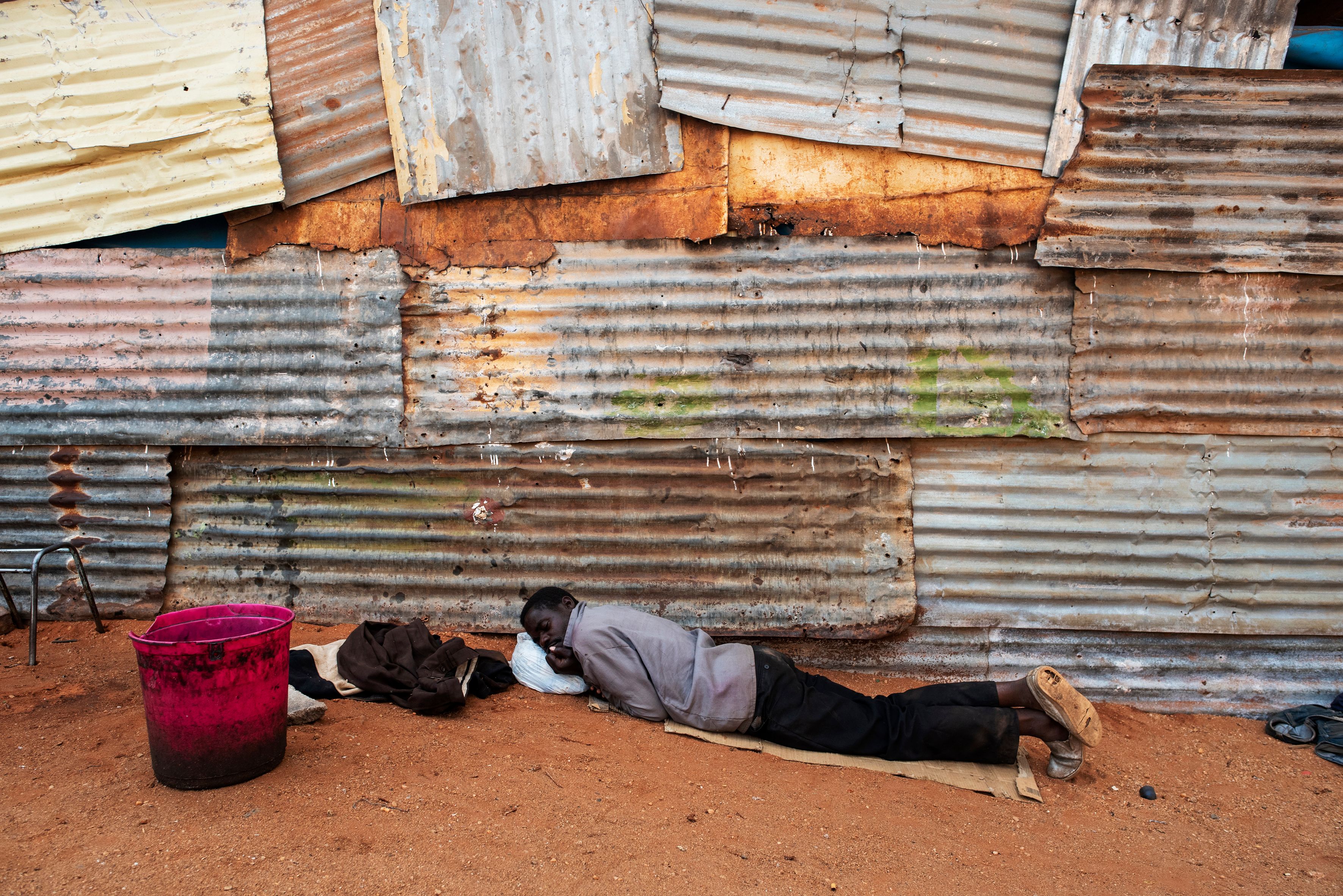 A Zimbabwean man rests outside a church at an informal migrant camp in Musina, South Africa.
