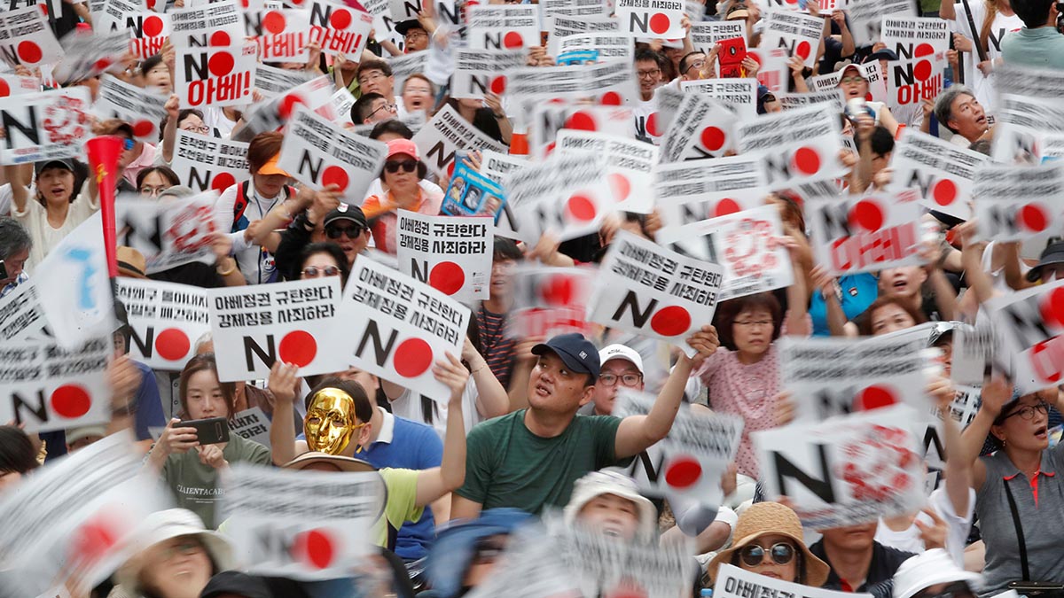 South Korean protesters wave banners that say 