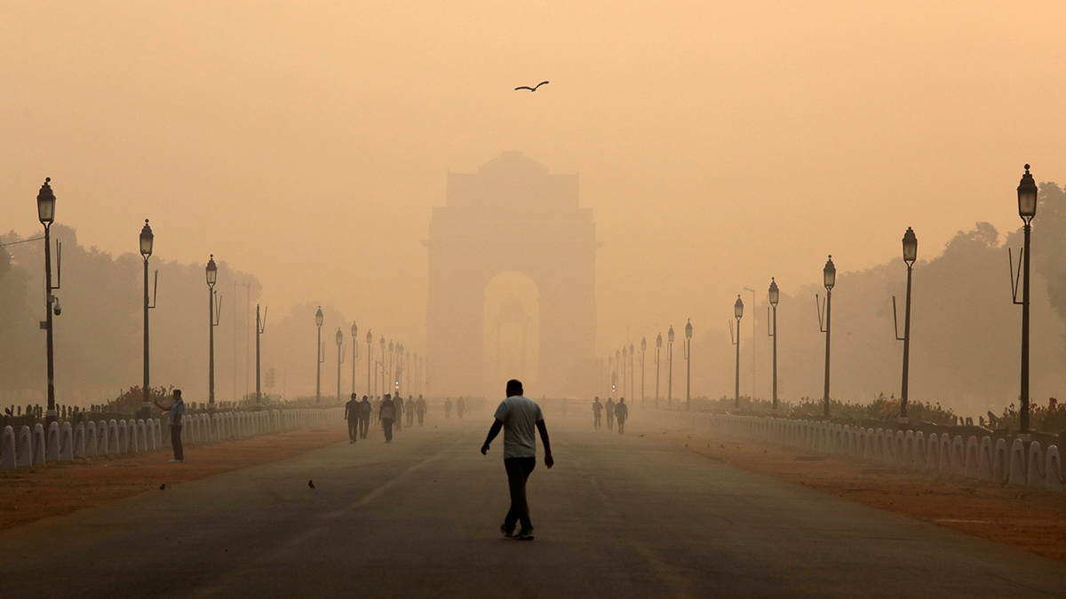A man walks in front of the India Gate shrouded in smog in New Delhi, India, October 29, 2018.