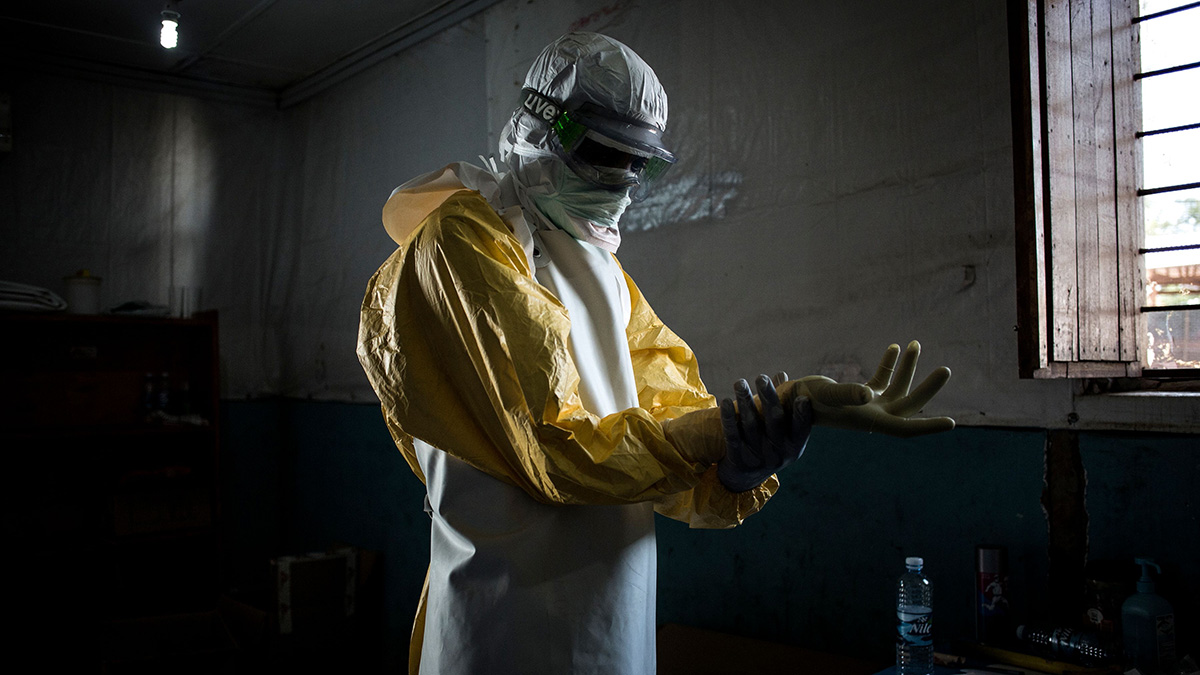 A health worker puts on protective equipment before entering the red zone of an Ebola treatment center in Bunia, Democratic Republic of Congo.
