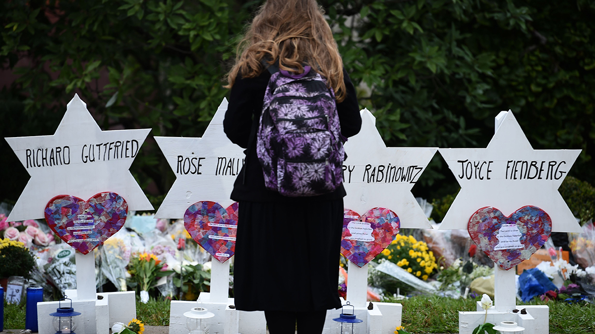 A woman stands at a memorial outside the Tree of Life synagogue after a shooting there left 11 people dead in the Squirrel Hill neighborhood of Pittsburgh on October 27, 2018.