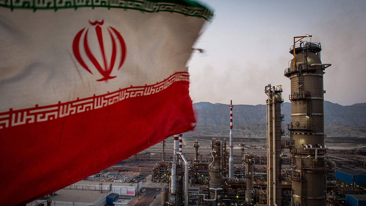 An Iranian national flag flies over a refinery in Bandar Abbas, Iran.