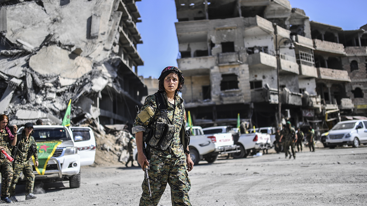 Kurdish fighters of the Syrian Democratic Forces gather in Raqqa, shortly after retaking it from the Islamic State.