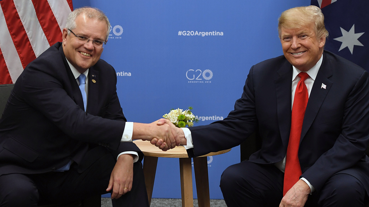 Scott Morrison and Donald Trump smile while shaking hands.