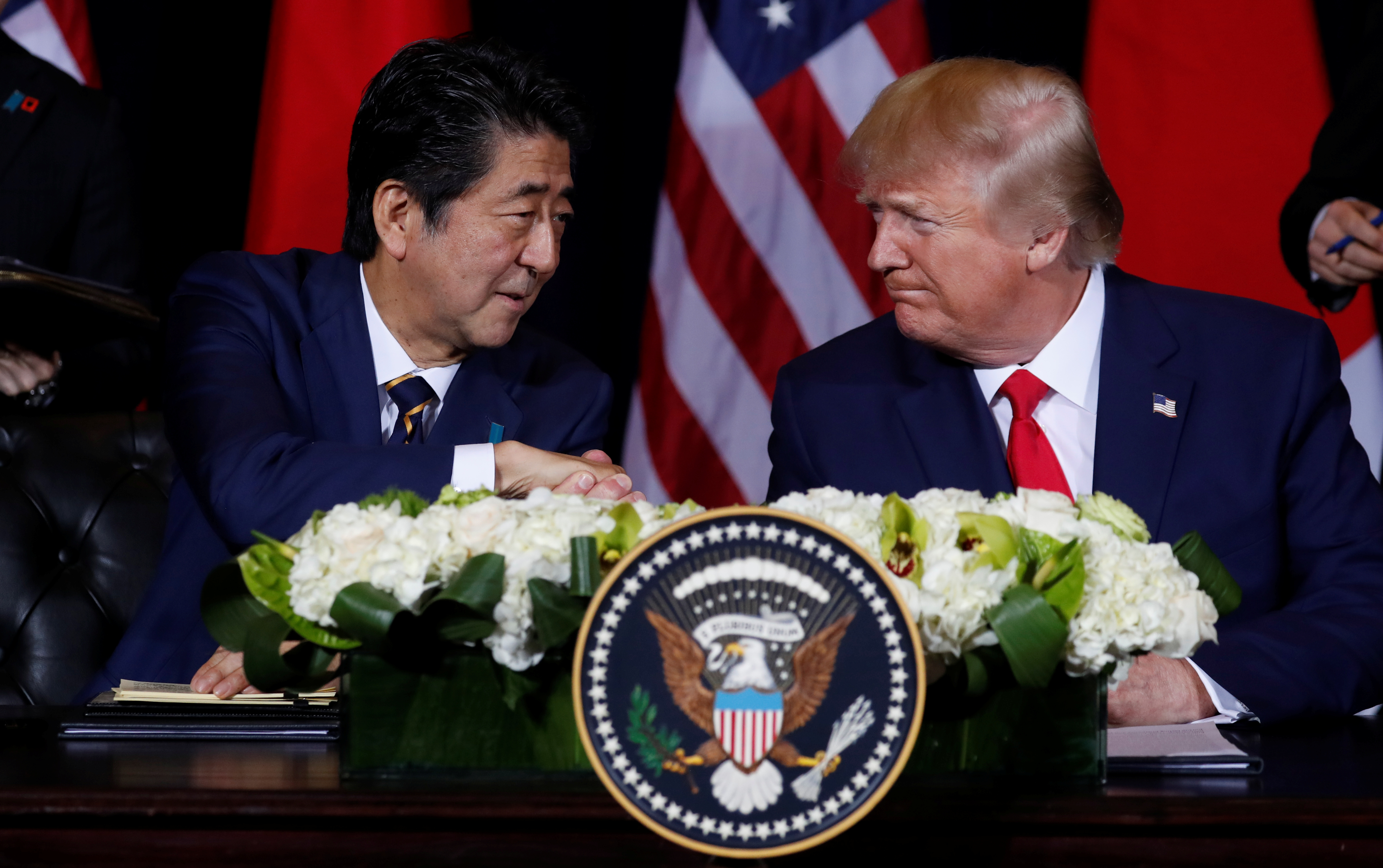 Shinzo Abe and Donald Trump shake hands