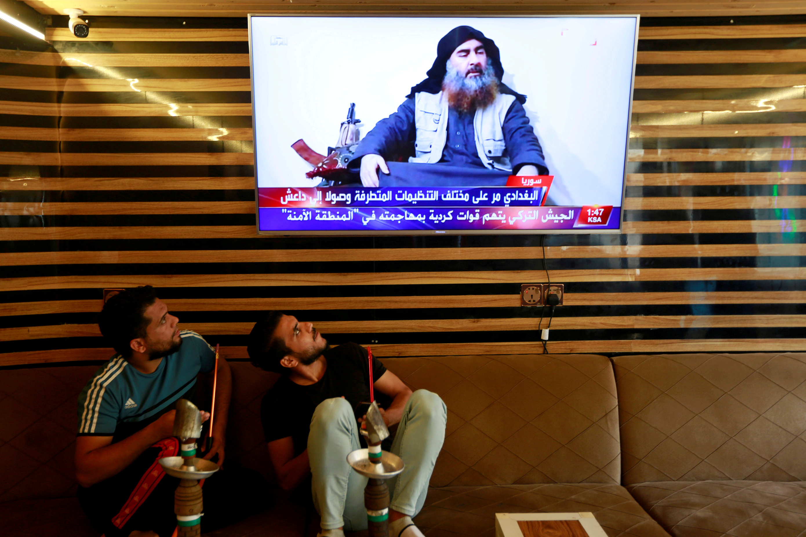 Iraqi youth watch news of Islamic State leader Abu Bakr al-Baghdadi’s death.