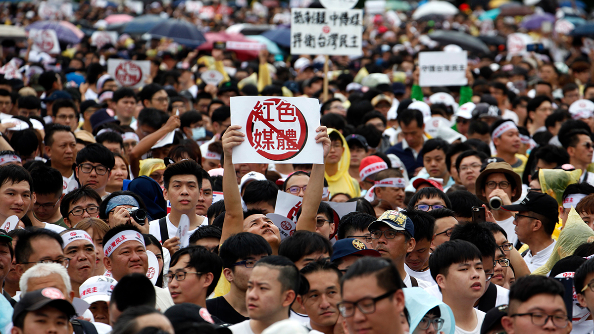 People hold signs in Taipei that read 