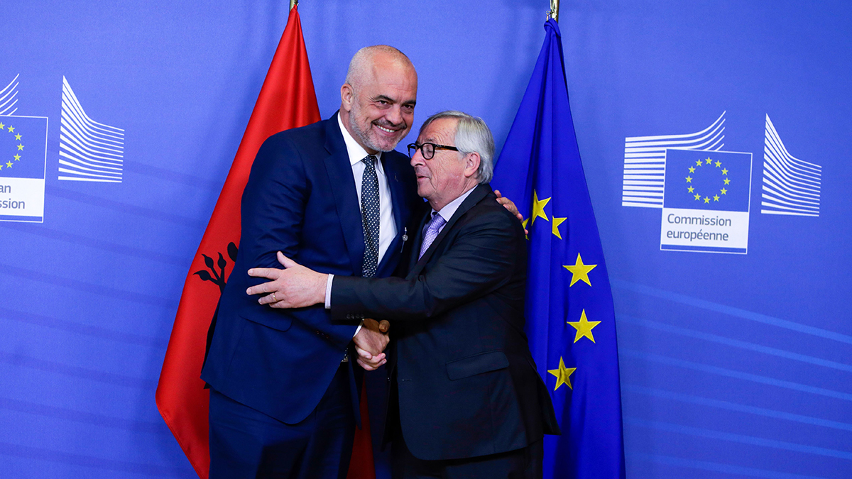 Former European Commission President Jean-Claude Juncker shakes hands with Albanian Prime Minister Edi Rama in Brussels.
