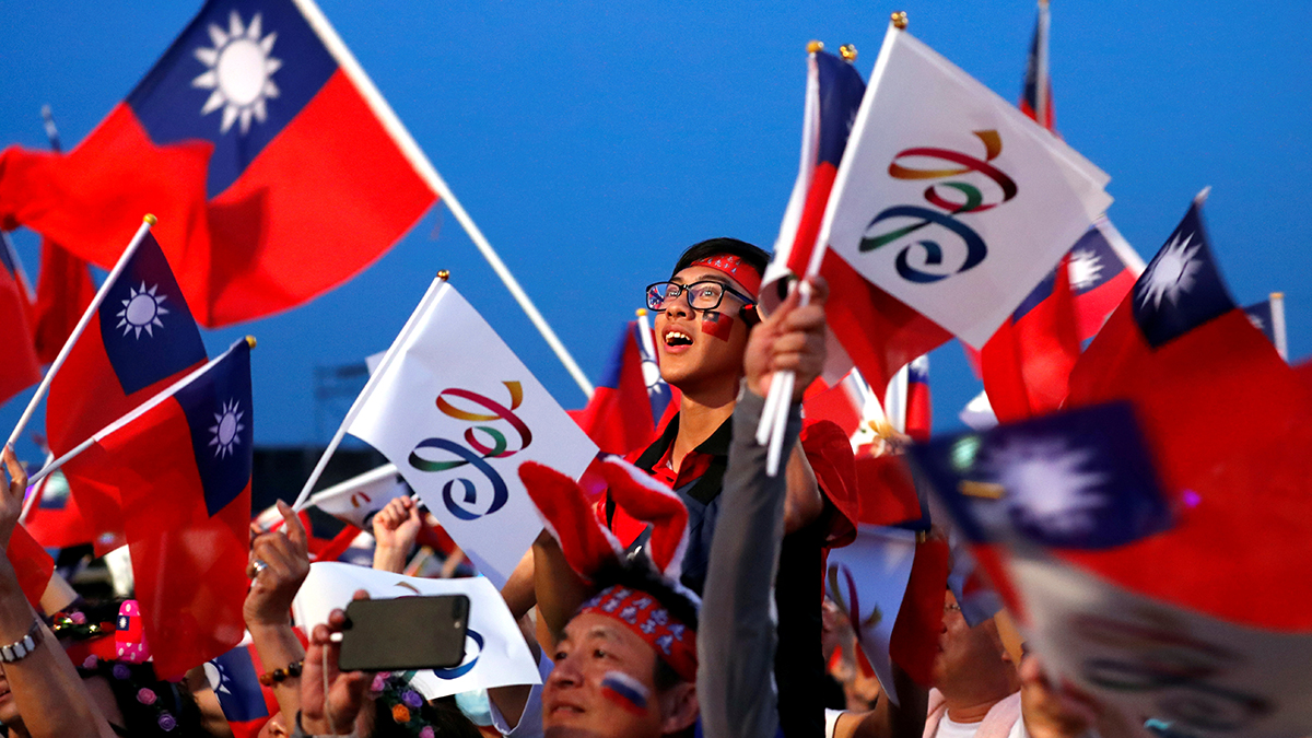 People wave Taiwan and KMT flags. 