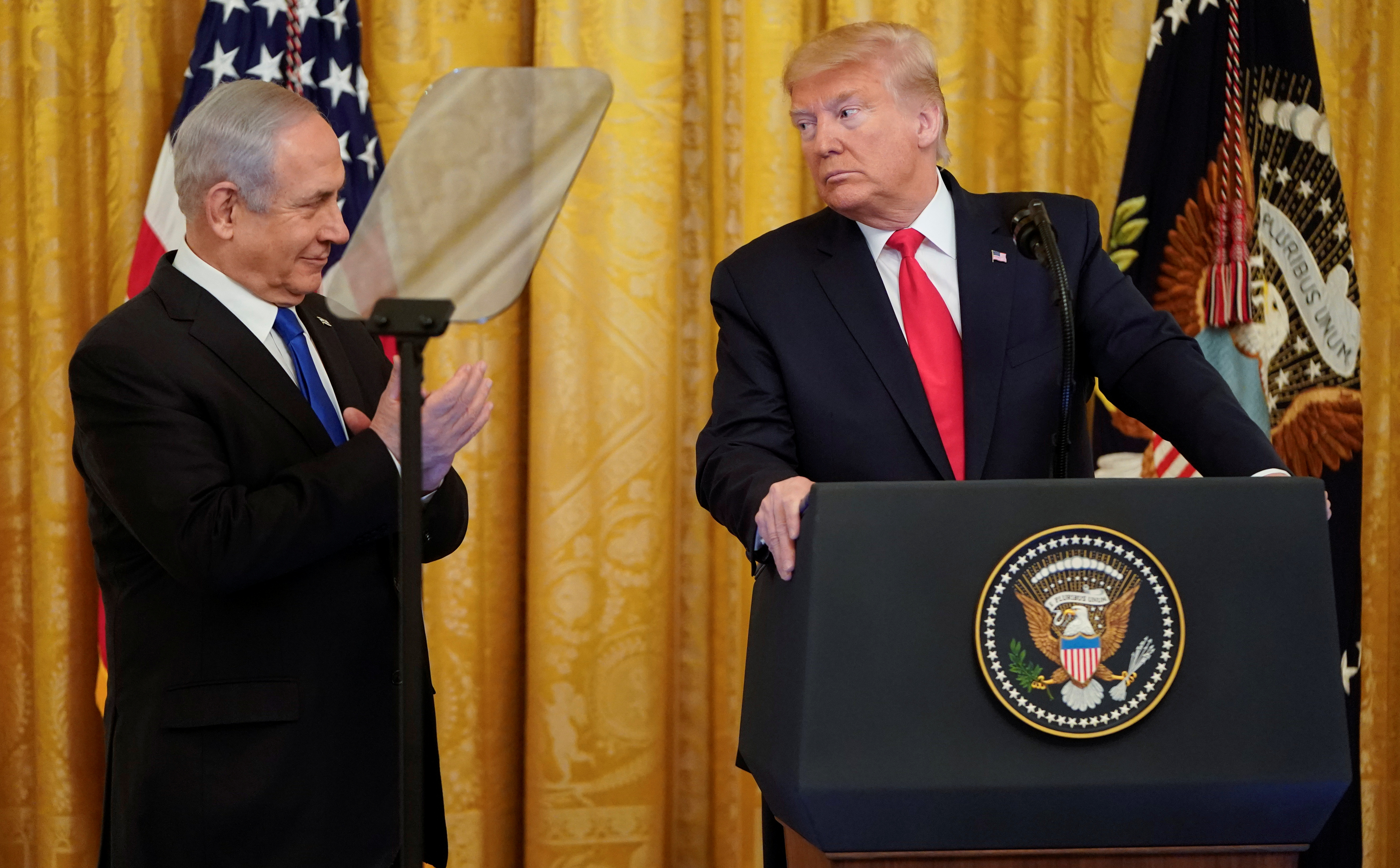 U.S. President Donald Trump looks at Israeli Prime Minister Benjamin Netanyahu during a joint news conference to announce a new Middle East peace plan in the East Room of the White House.