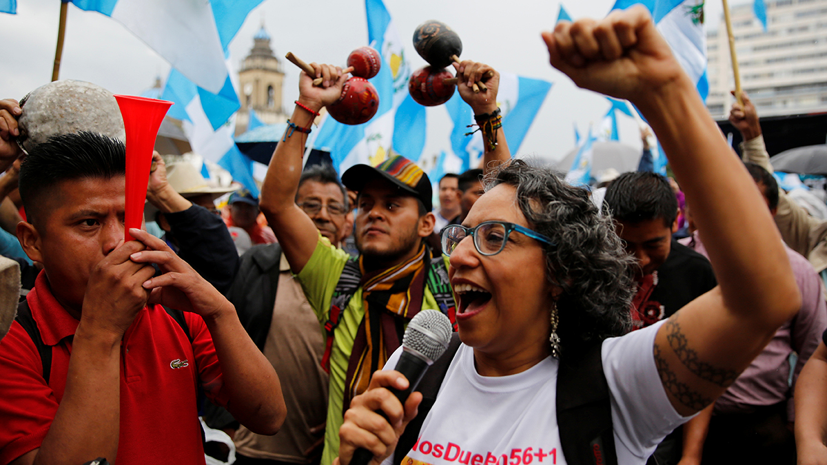 Demonstrators wave their arms and make noise during a protest against the disbanding of the CICIG in Guatemala City.