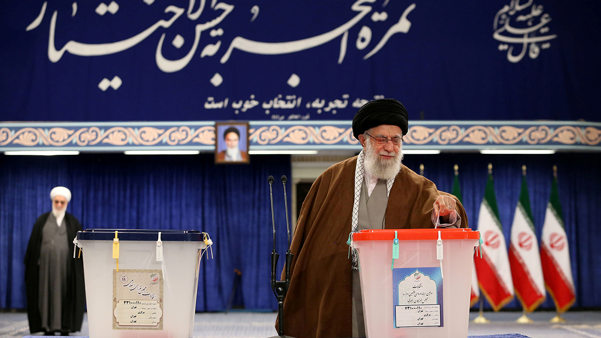 Iranian Supreme Leader Ali Khamenei places a ballot into a box at a polling station in Tehran.