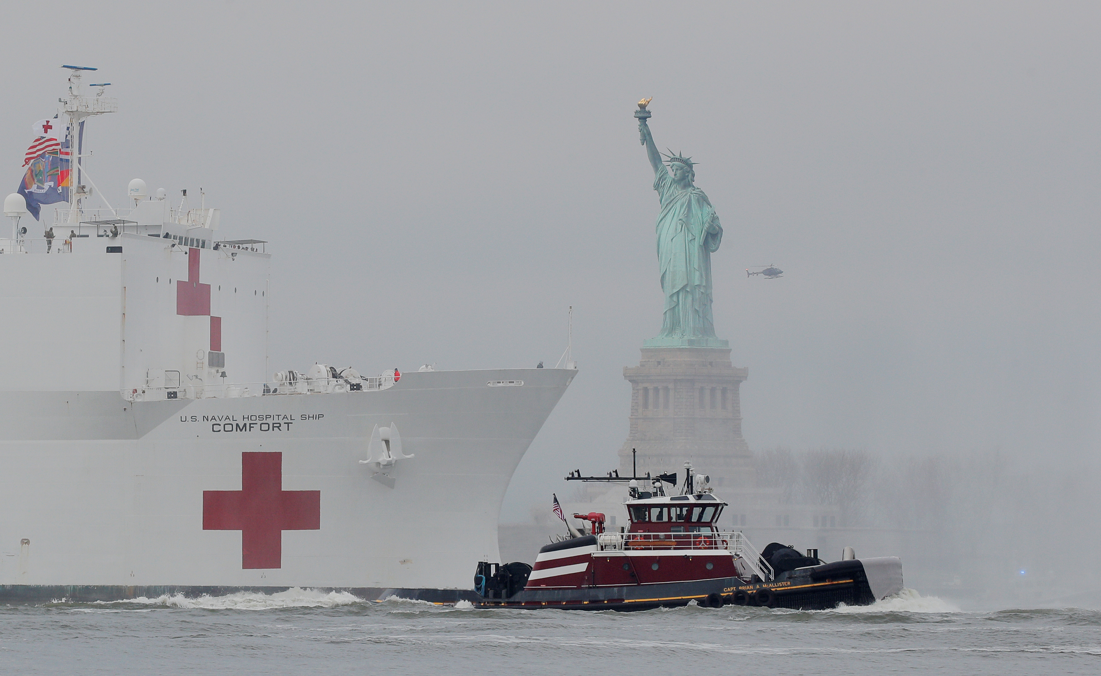 A naval hospital ship sails by the Statue of Liberty in New York.
