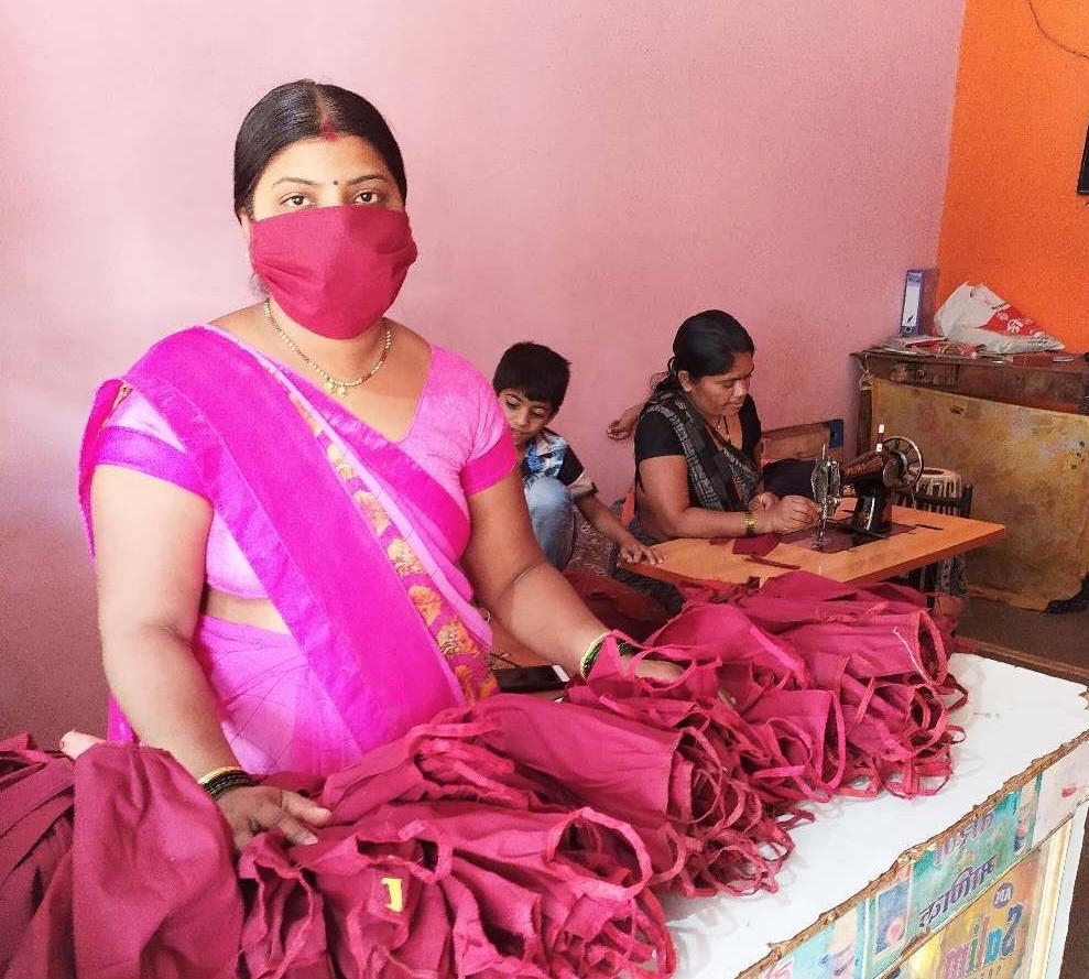Women sewing pink garments.