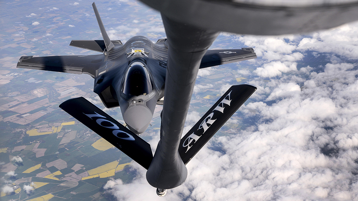 An Air Force F-35 Lightning II fighter jet prepares to couple with a KC-135 Stratotanker above Estonia. 