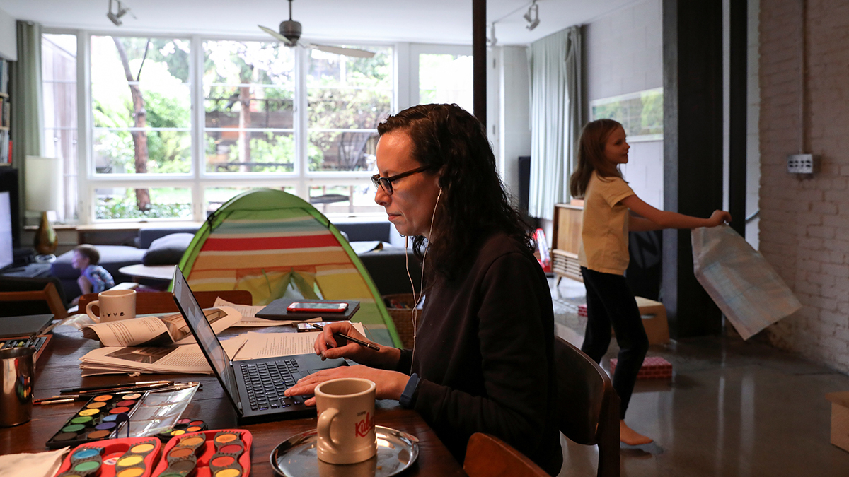 A woman works from home surrounded by art supplies her daughter needs for a school project during the outbreak of the coronavirus in Brooklyn, New York City.
