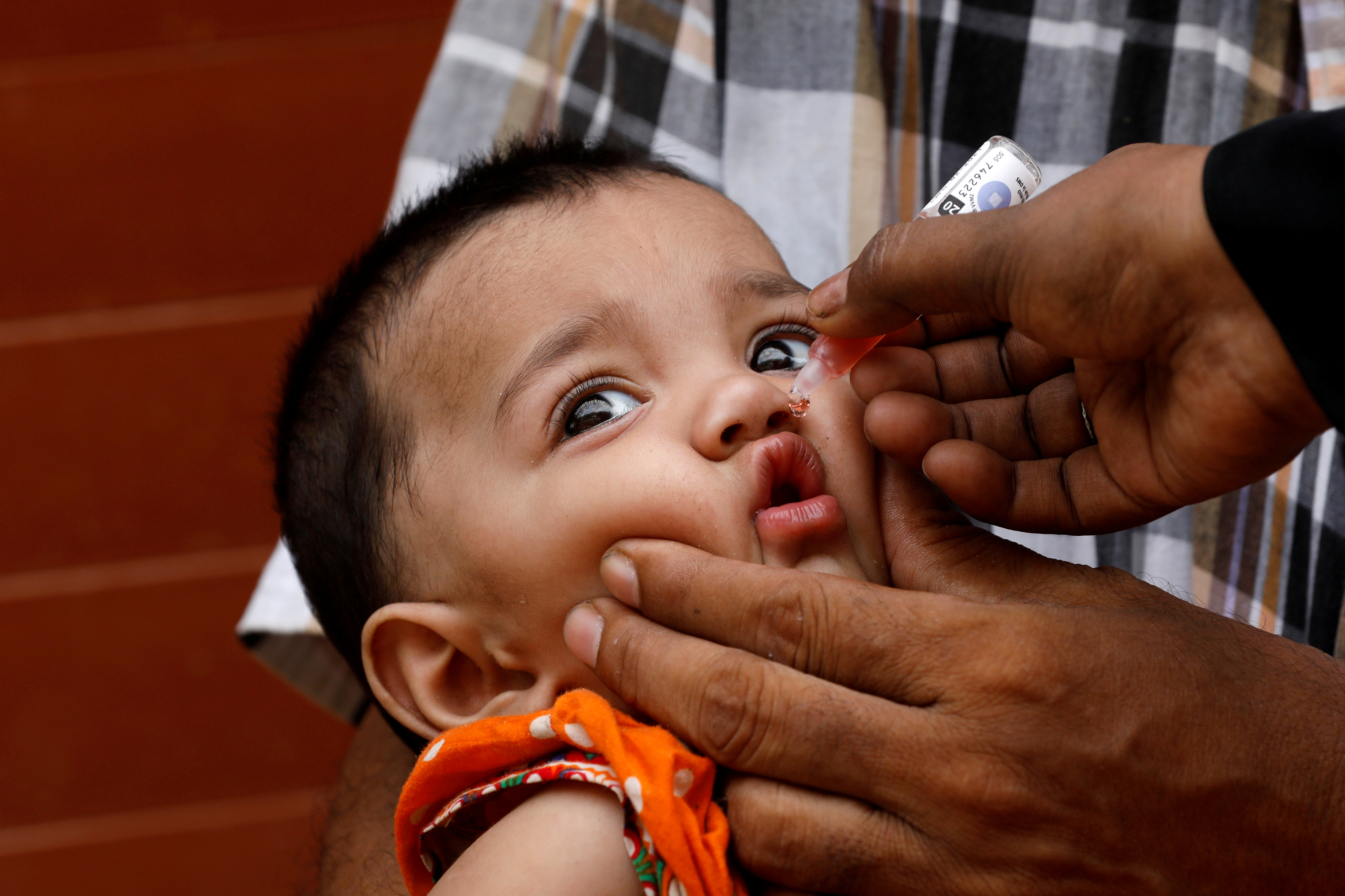 A child receives polio vaccine drops in an anti-polio campaign in Karachi, Pakistan.
