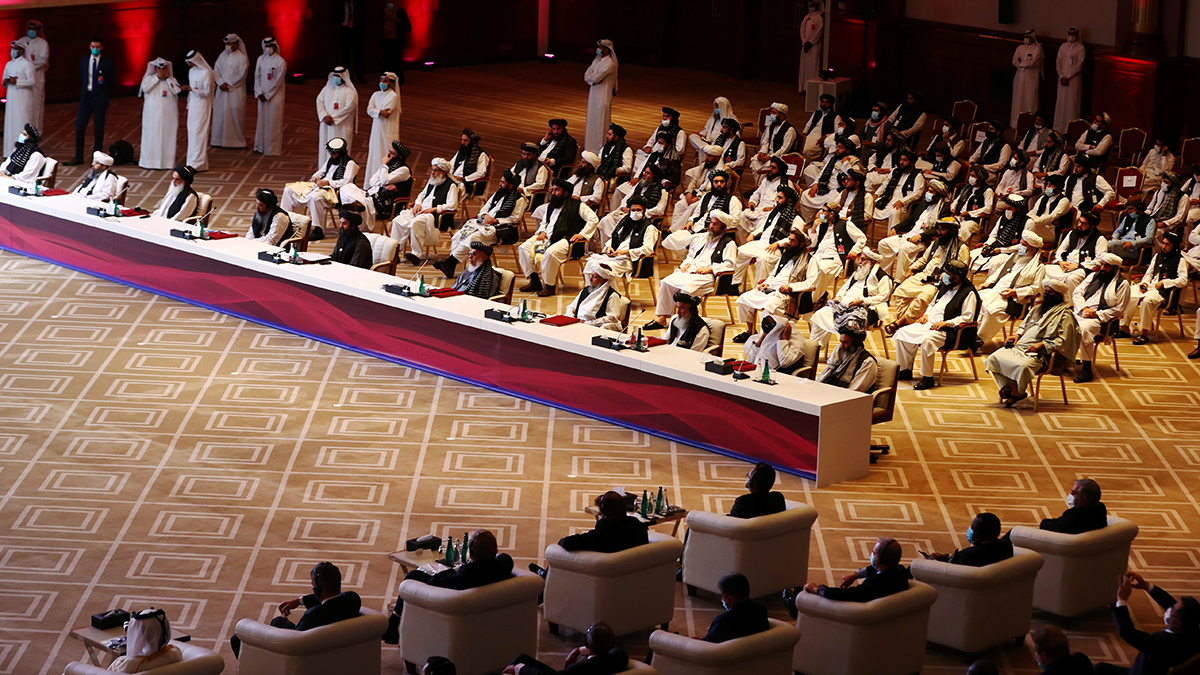 An aerial photo of people sitting in chairs in a conference room in Doha.