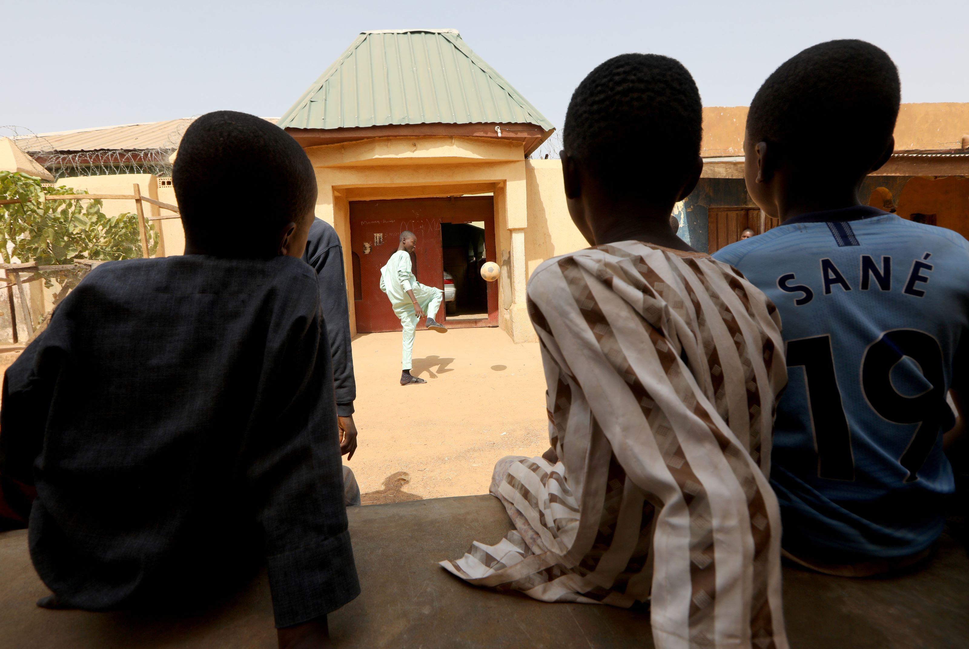 A freed Nigerian schoolboy plays football as he returns home, after he was rescued by security forces, in Kankara, Nigeria December 19, 2020.