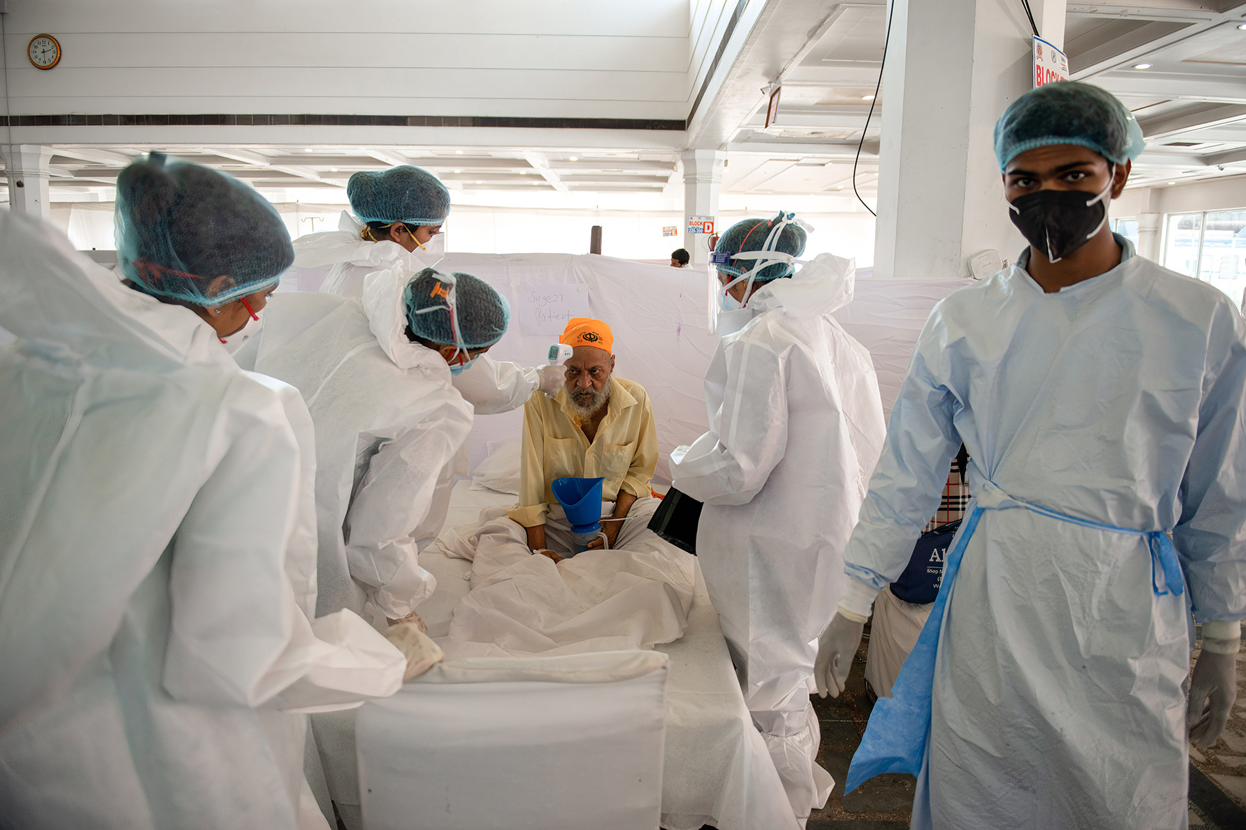 A doctor and nurses in full PPE take extra care of a diabetes patient with COVID-19 in New Delhi, India.