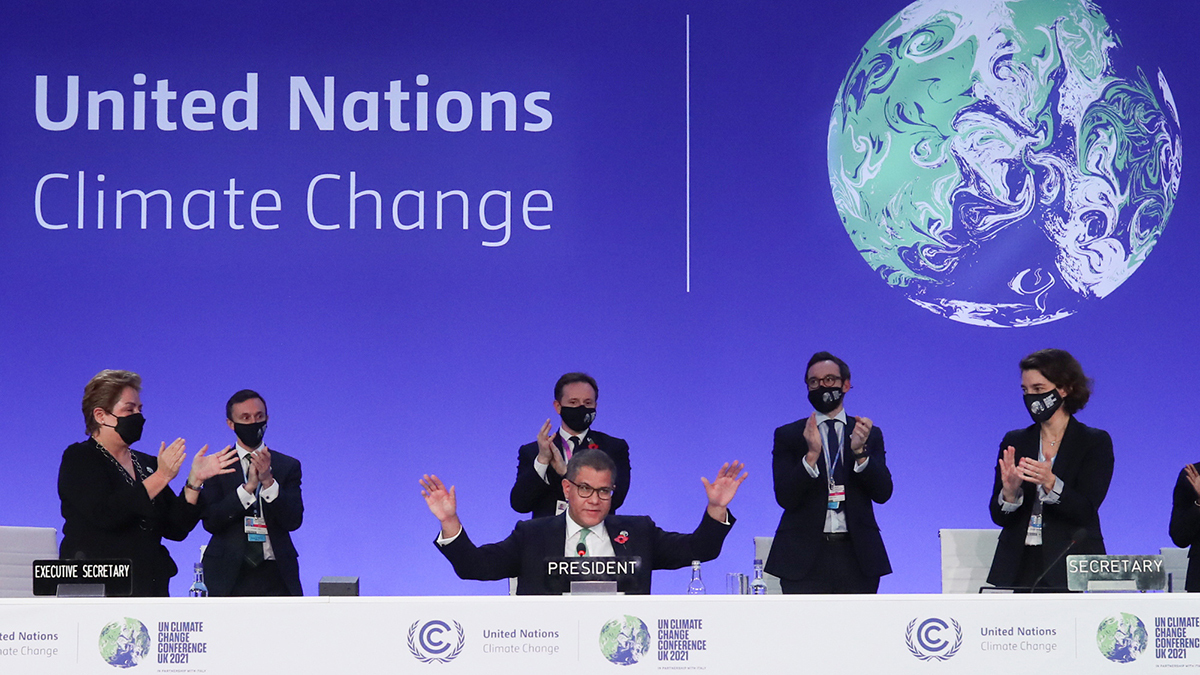COP26 officials clap.