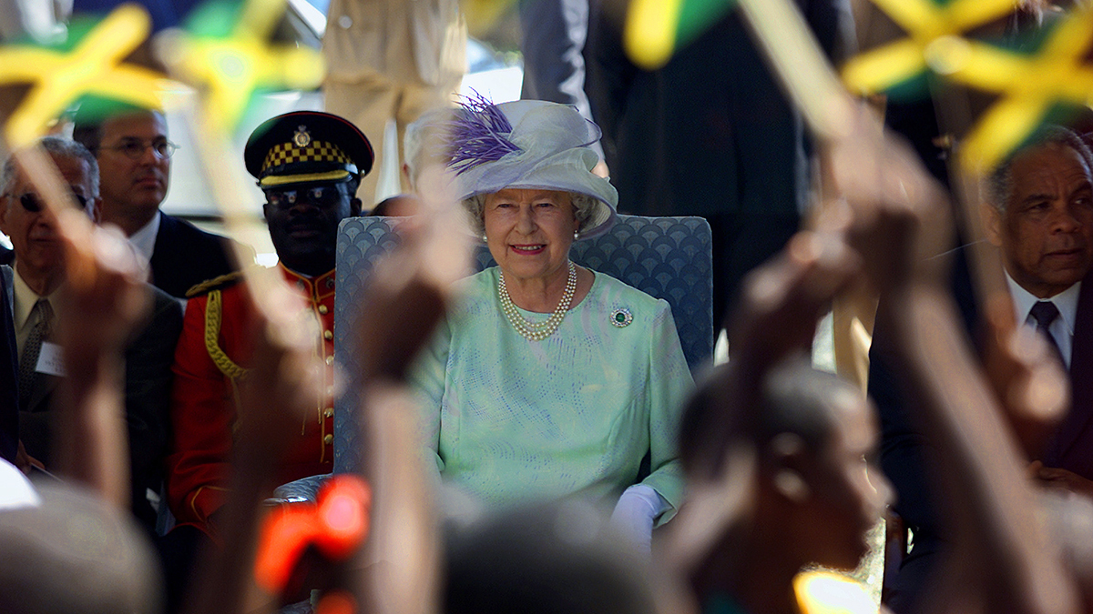 Jamaican schoolchildren welcome Queen Elizabeth II during her 2002 visit to the country.