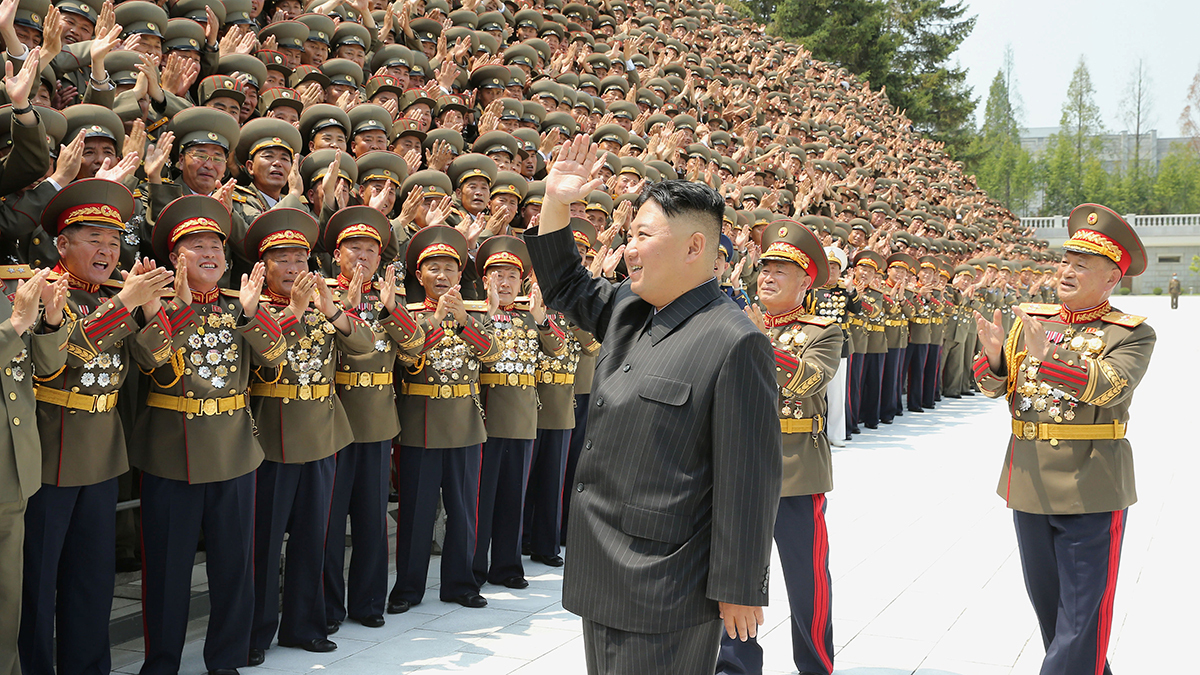 Kim Jong-un waves to a crowd of North Korean military leaders. 