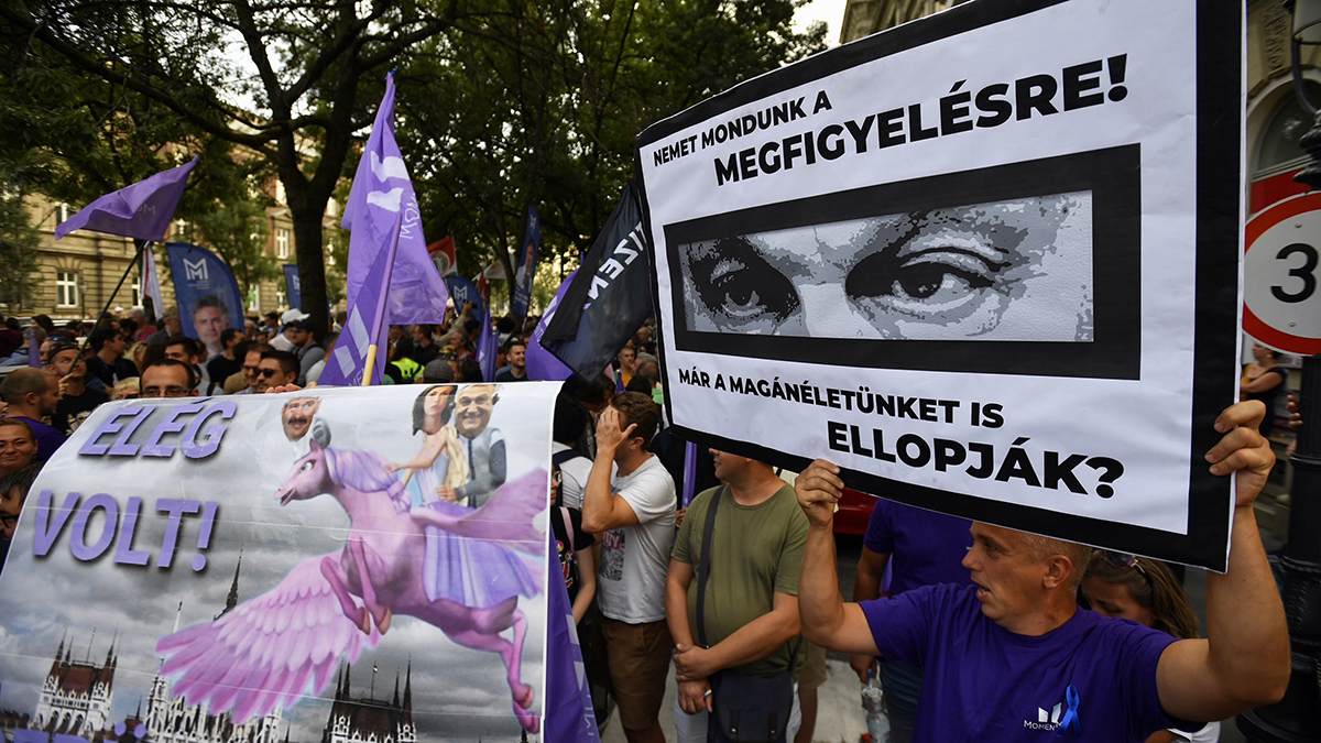 A protester's poster shows Prime Minister Viktor Orban's eyes and reads 