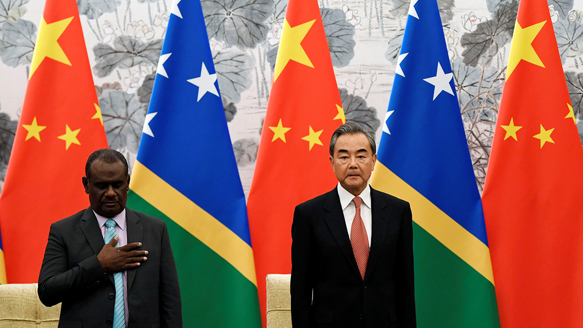 Chinese Foreign Minister Wang Yi and Solomon Islands Foreign Minister Jeremiah Manele stand next to each other.