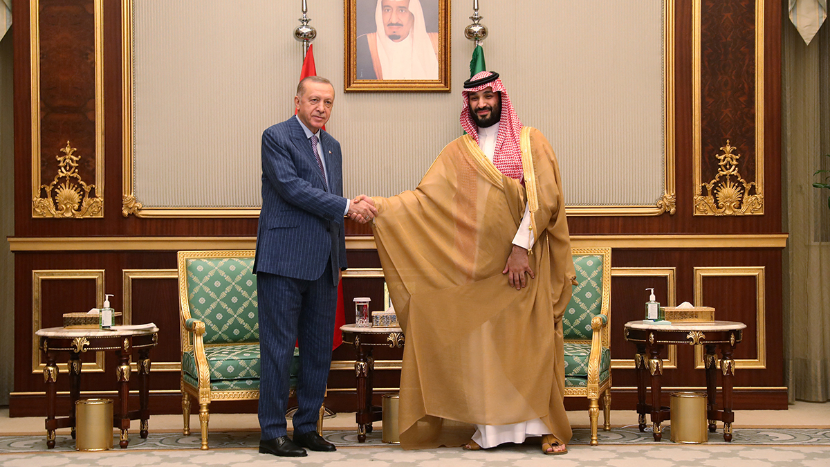 Turkish President Tayyip Erdogan shakes hands with Saudi Crown Prince Mohammed bin Salman