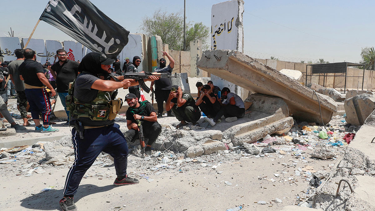 A supporter of Muqtada al-Sadr fires at security forces in Baghdad’s Green Zone.