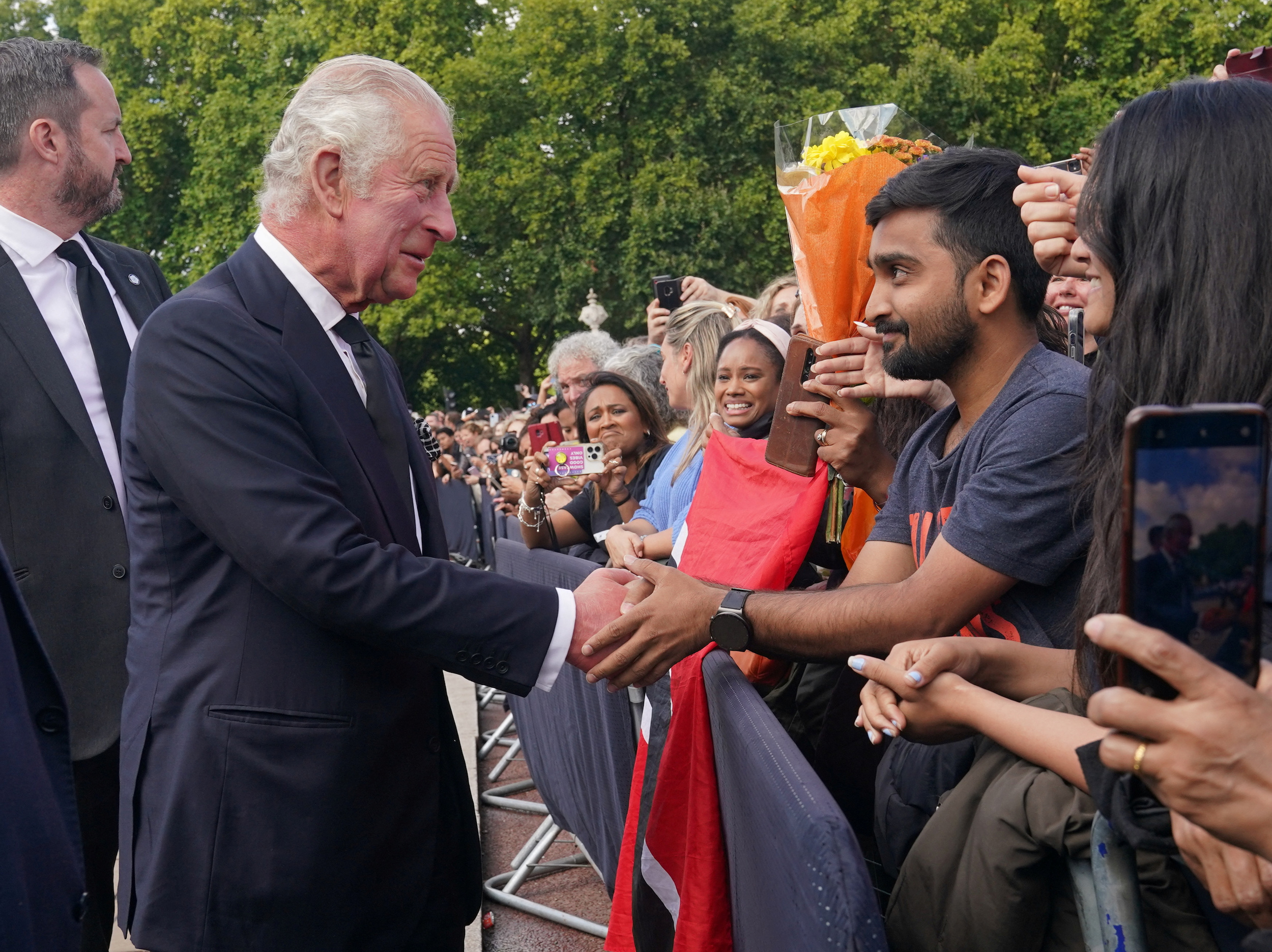 King Charles III greets crowds outside Buckingham Palace in London following the death of Queen Elizabeth II.