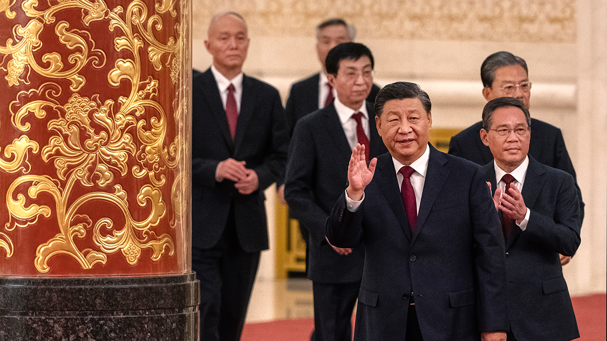 Xi Jinping waves as he walks with members of the Standing Committee. 