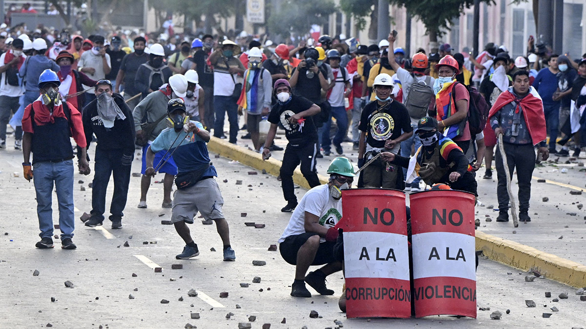 Protesters throw rocks at police during anti-government demonstrations in January in Lima, Peru.