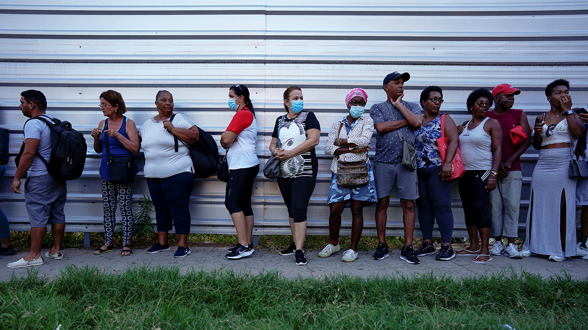 People wait in a line outside to buy foreign currency in Havana, Cuba.