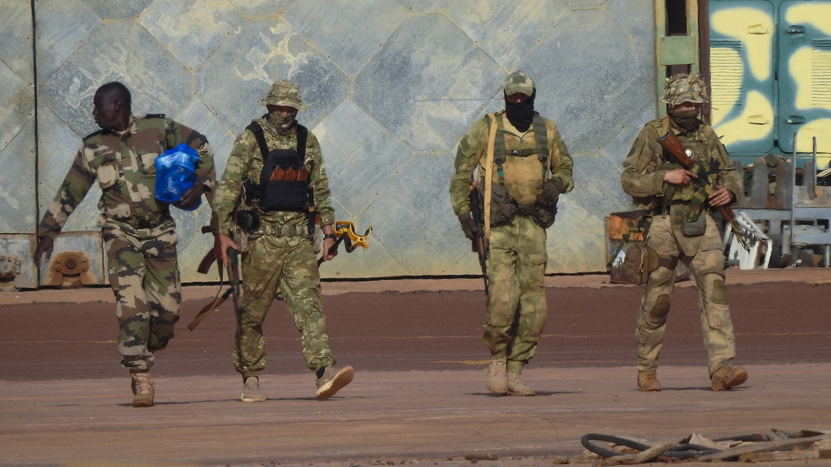 Three members of the Wagner Group, right, survey the streets in Northern Mali.