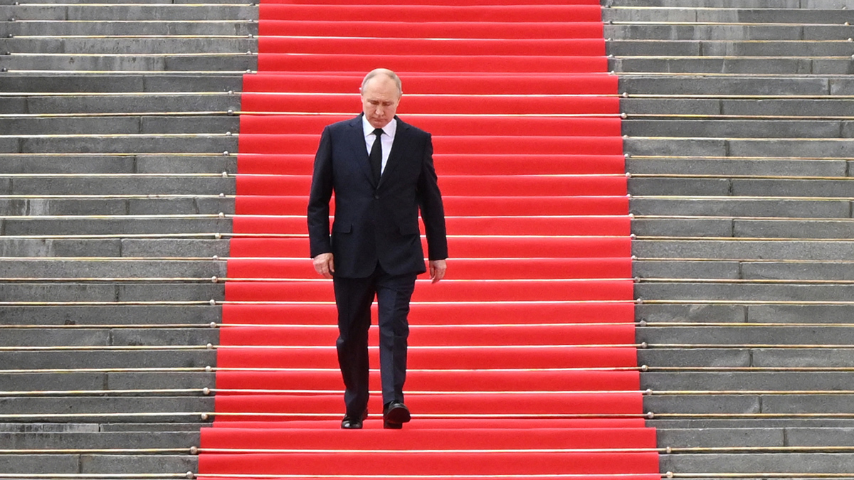 Russian President Vladimir Putin walks down the steps to address troops gathered on the grounds of the Kremlin on June 27, 2023. 