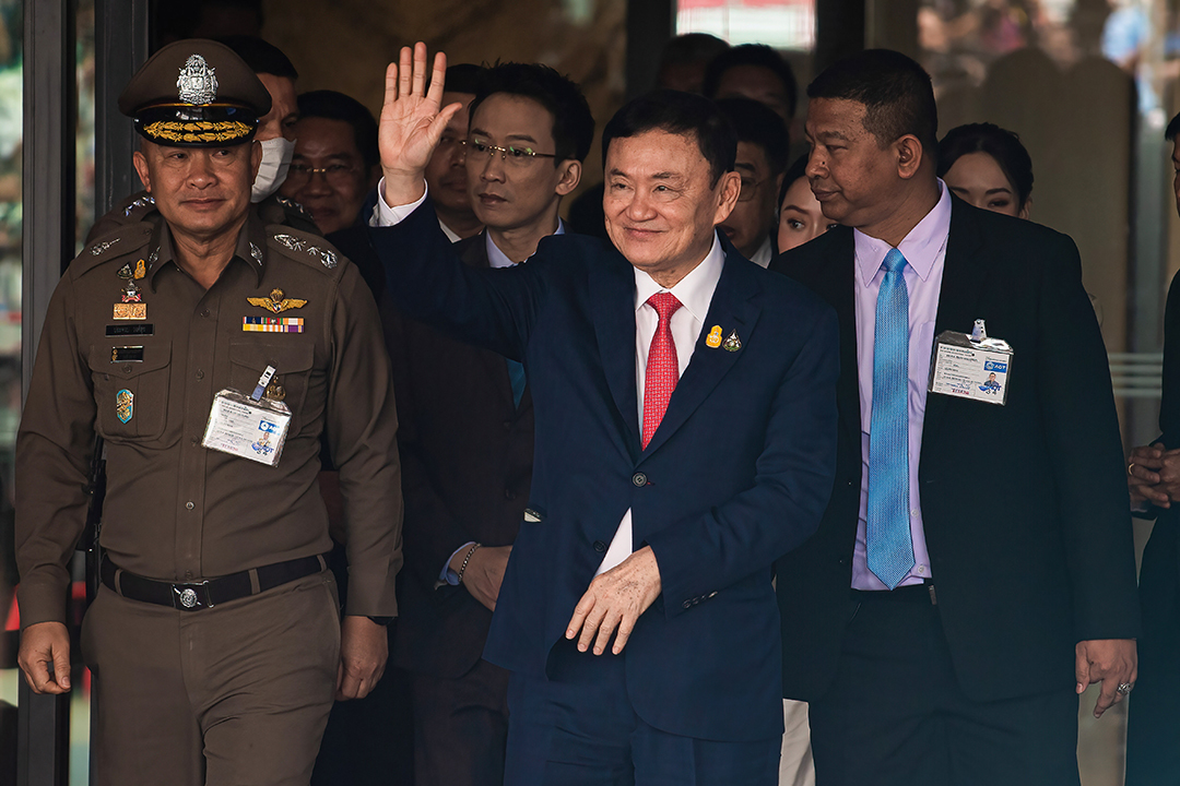 Former Thai Prime Minister Thaksin Shinawatra and his entourage arrive at Don Mueang International Airport in Bangkok