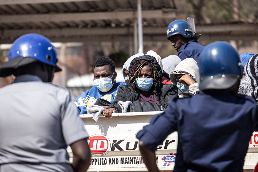 Police officers stand guard as Zimbabwean election observers await their court hearing after being arrested for the alleged unlawful tabulation of election results.
