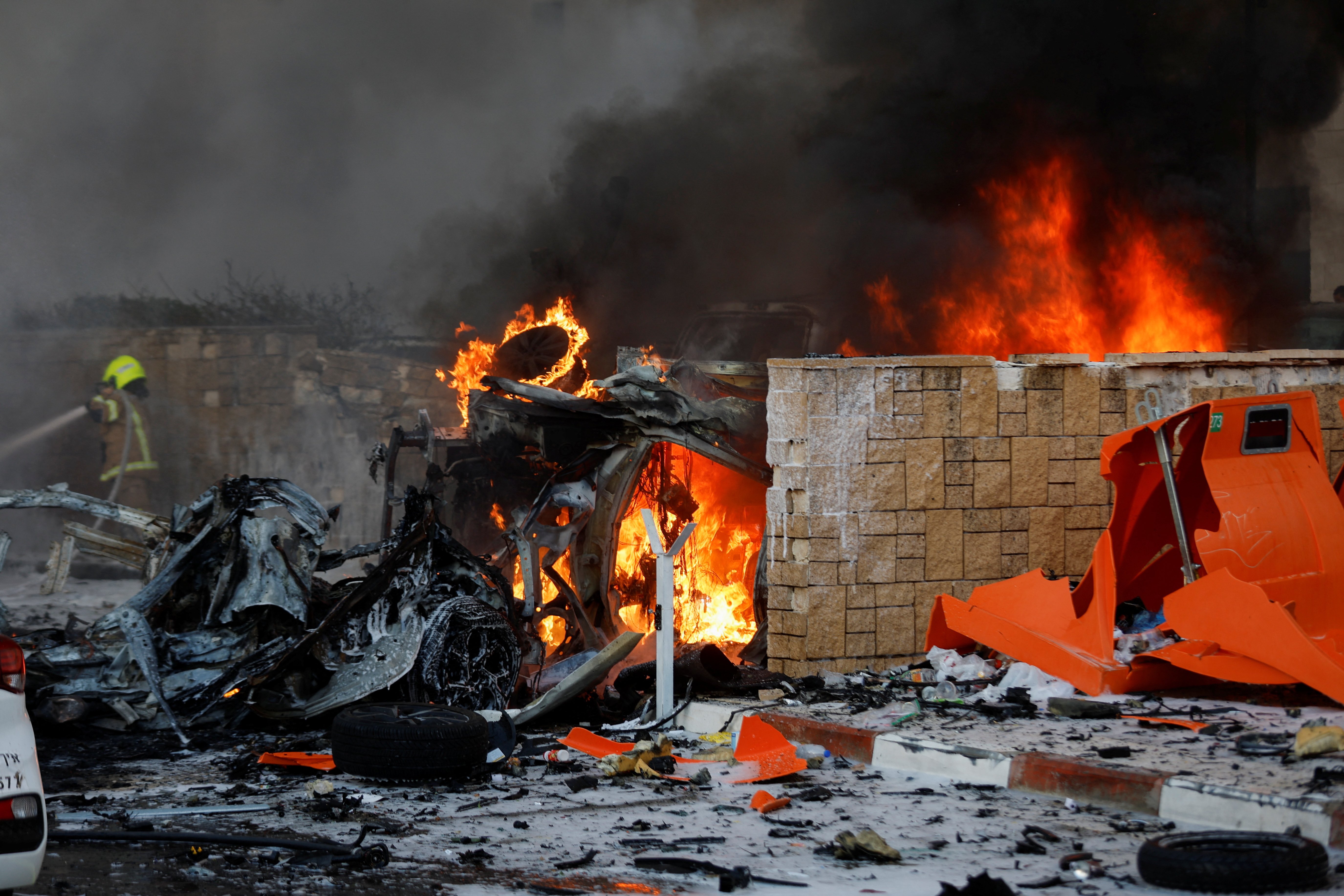 Objects burn on a road after rockets were launched from the Gaza Strip, in Ashkelon, Israel 