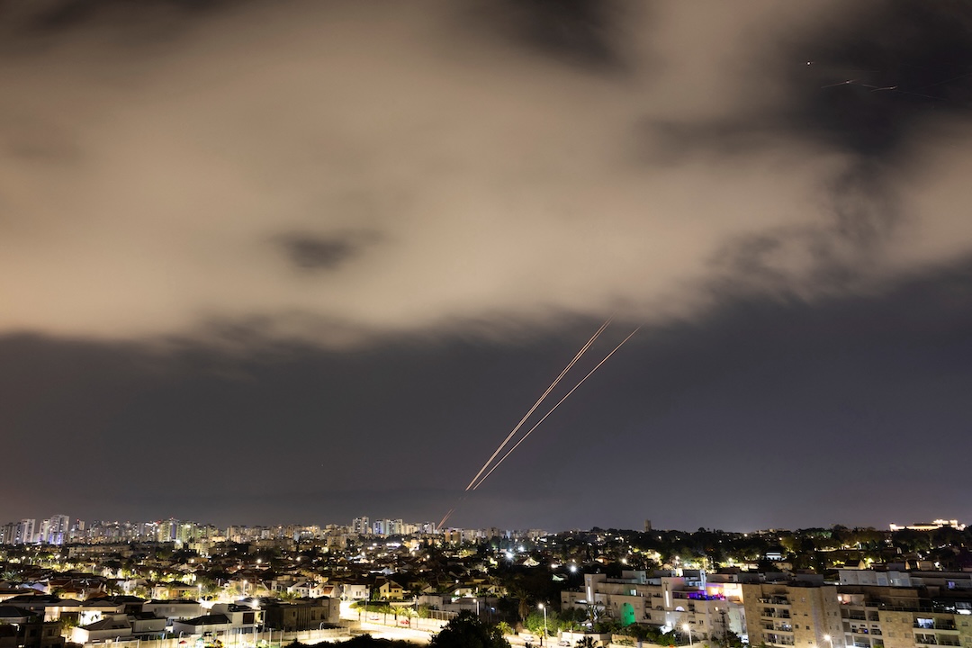 Objects in the sky are intercepted over a city.