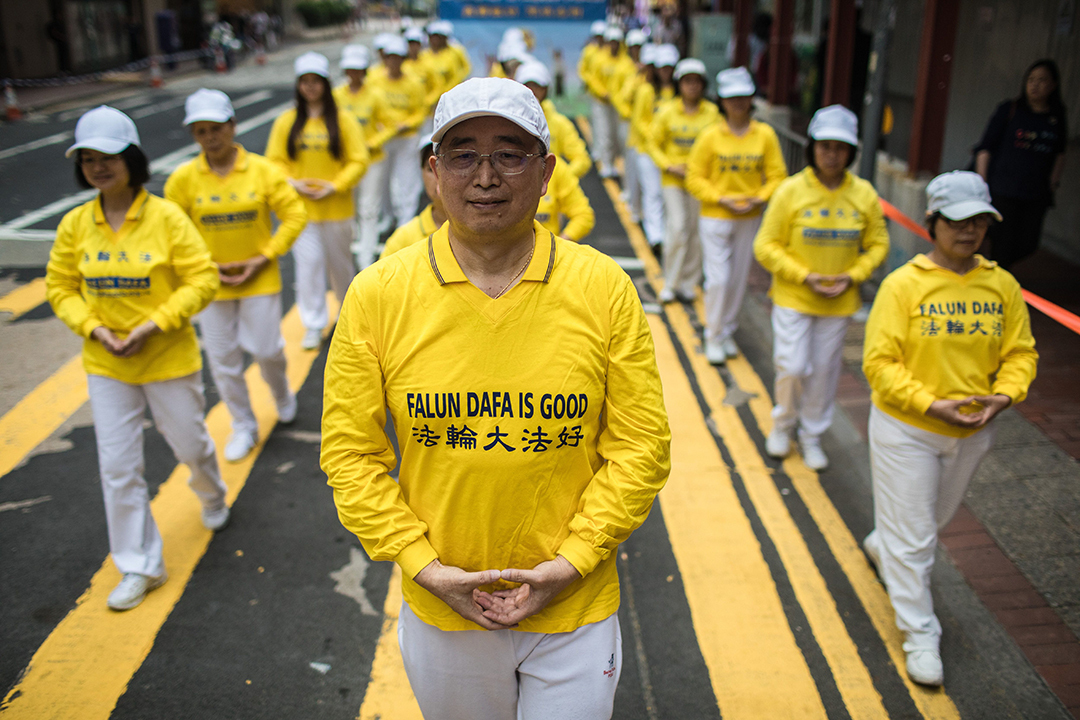 Supporters of the Falungong spiritual movement, a group banned in mainland China, take part in a march in Hong Kong on April 27, 2019, to observe the 20th anniversary of a large demonstration in Beijing which led their a crackdown against the movement.