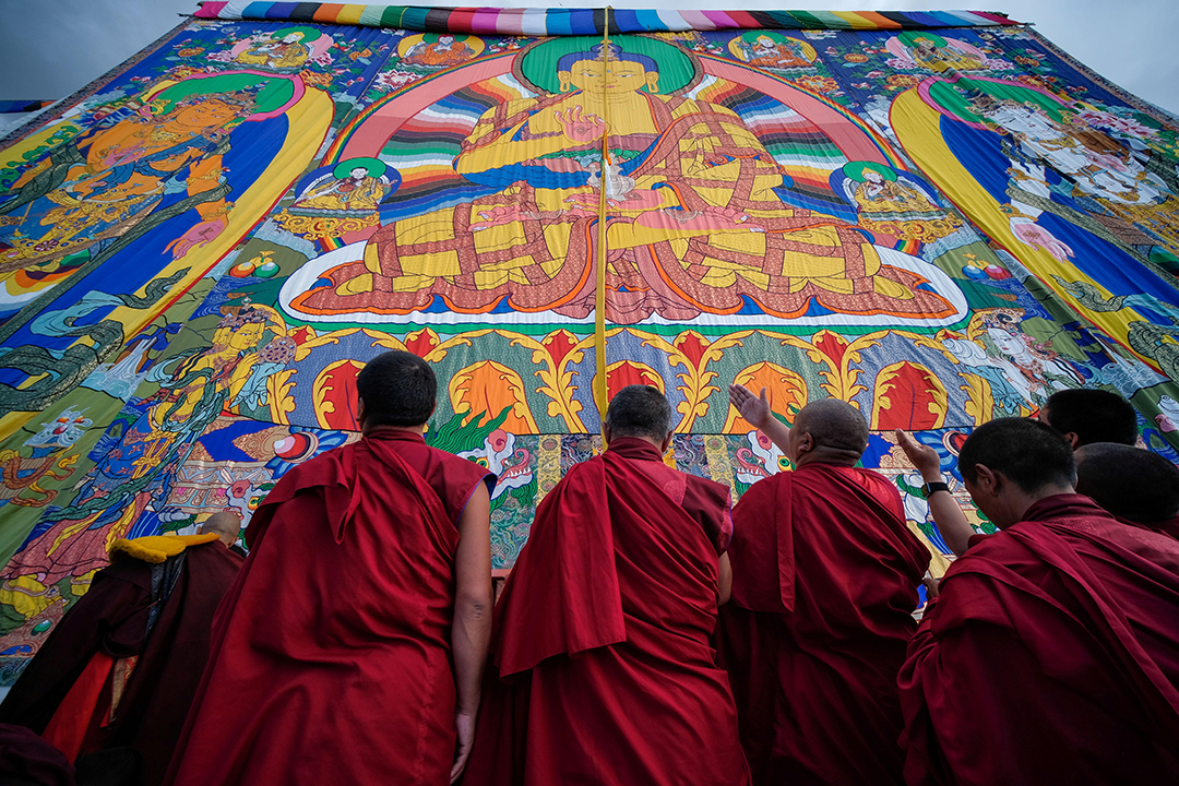 Tibetan Buddhist monks look at a mural in the Tashilhunpo Monastery in Shigatse, Tibet Autonomous Region, China.