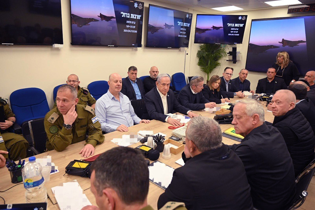 Prime Minister Benjamin Netanyahu and the rest of the war cabinet sit in a conference room